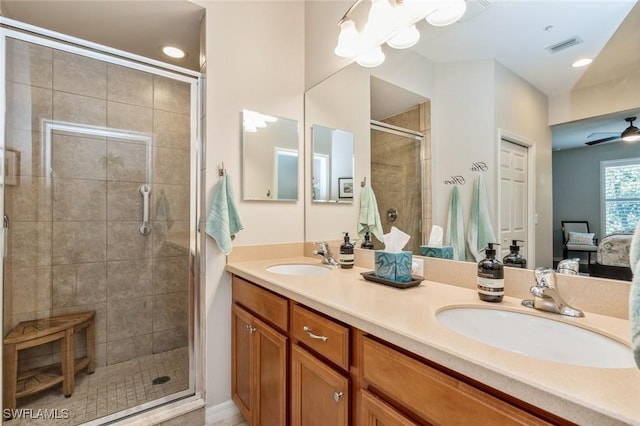 bathroom featuring ceiling fan, an enclosed shower, and vanity