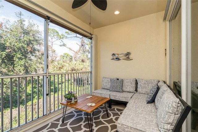 sunroom featuring ceiling fan and a wealth of natural light