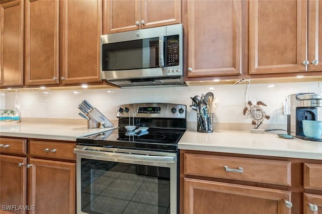 kitchen featuring appliances with stainless steel finishes and decorative backsplash