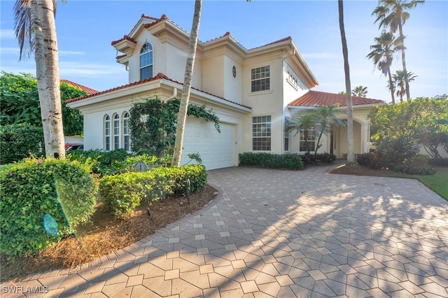 mediterranean / spanish-style home featuring a garage