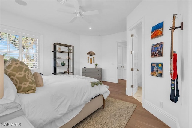 bedroom with hardwood / wood-style flooring and ceiling fan