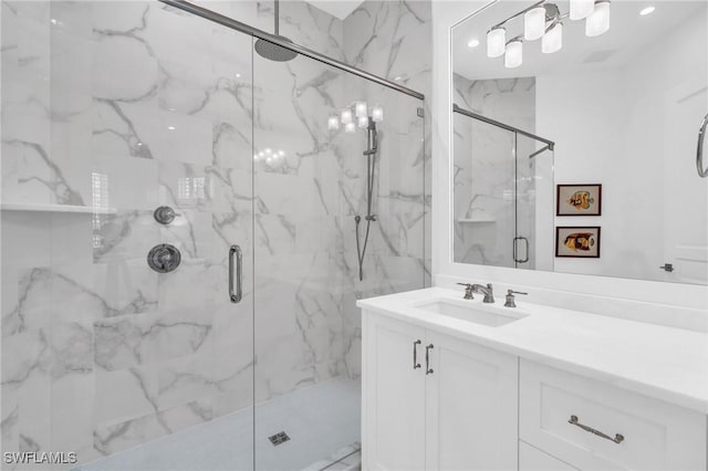 bathroom featuring vanity and a shower with door