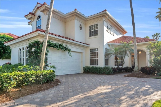 mediterranean / spanish home featuring a garage