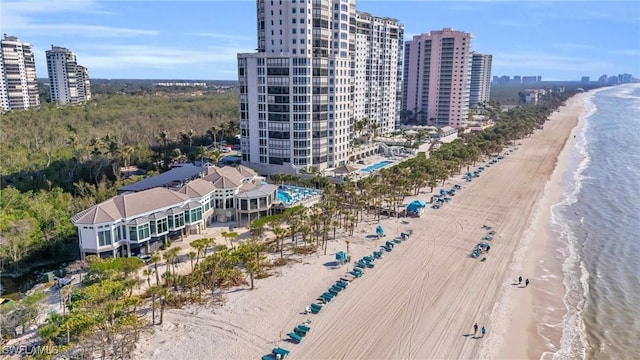 drone / aerial view featuring a water view and a beach view