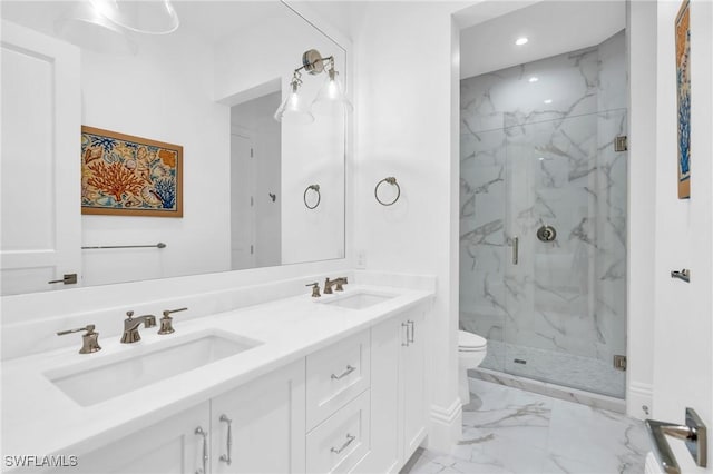 bathroom featuring vanity, toilet, and a shower with shower door