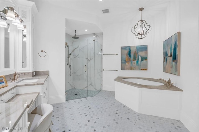 bathroom with vanity, shower with separate bathtub, and an inviting chandelier