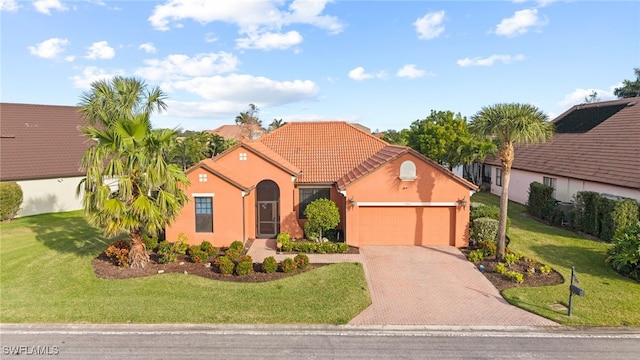 view of front of home with a garage and a front yard