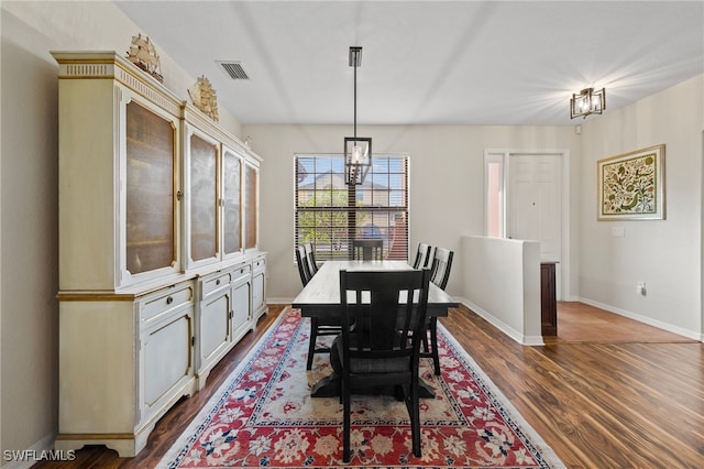 dining area with a notable chandelier and hardwood / wood-style floors