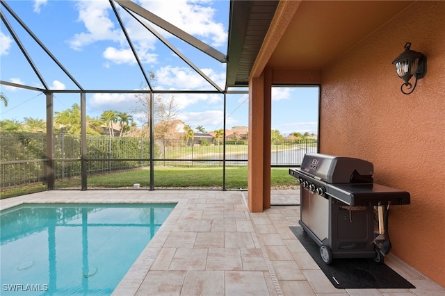 view of pool featuring glass enclosure, a patio area, a yard, and area for grilling