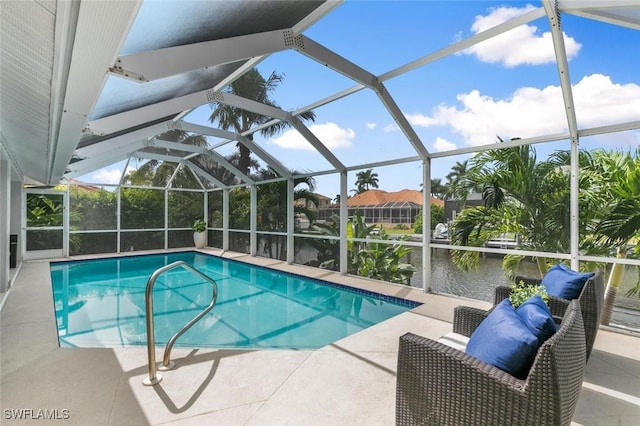 view of swimming pool with a patio, a water view, and a lanai