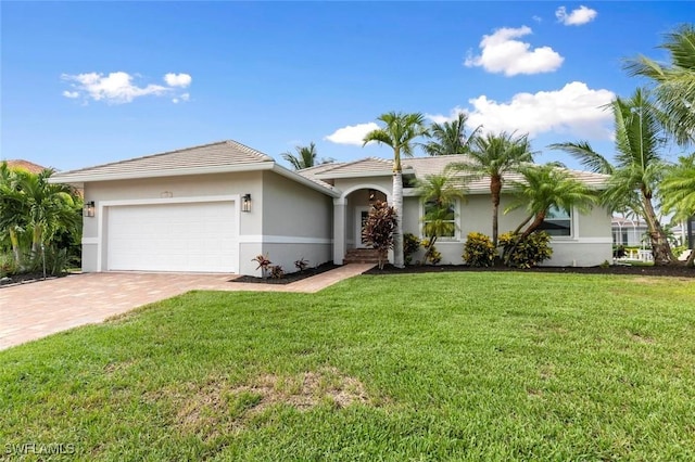 single story home with a front yard and a garage