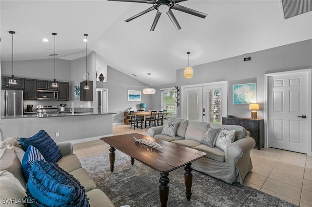 living room with ceiling fan, lofted ceiling, light tile patterned floors, and french doors