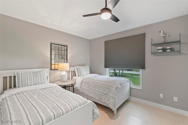 tiled bedroom featuring ceiling fan