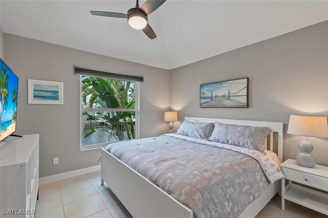 tiled bedroom featuring ceiling fan