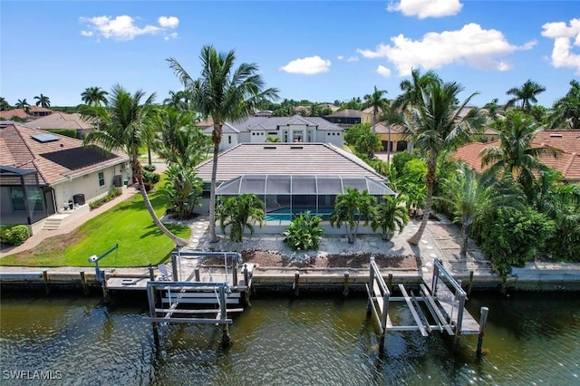 dock area with a lanai, a lawn, and a water view