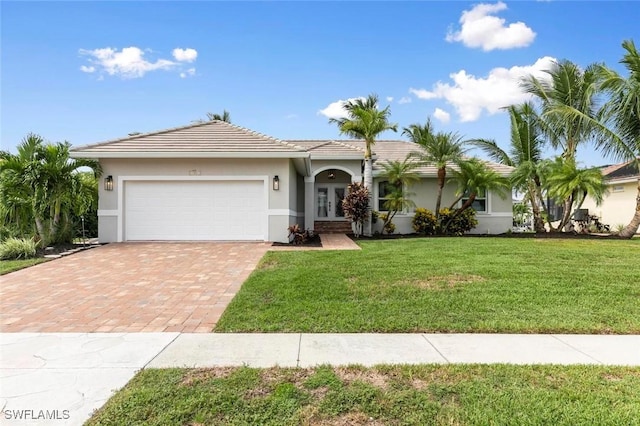 view of front of home featuring a front yard and a garage