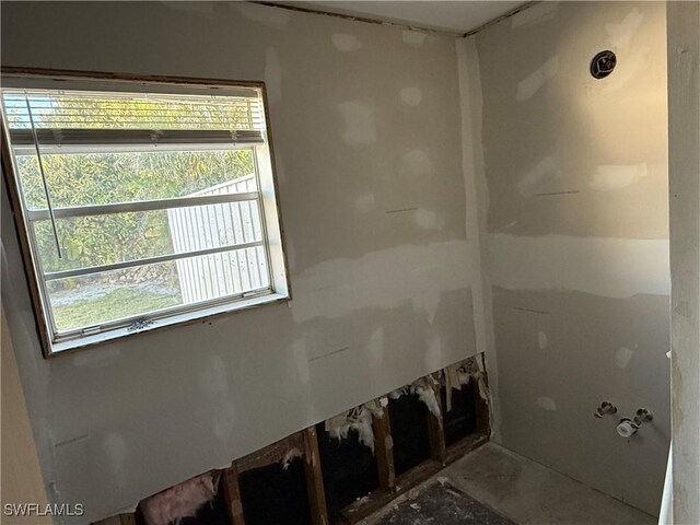 unfurnished living room featuring ceiling fan, lofted ceiling, and sink