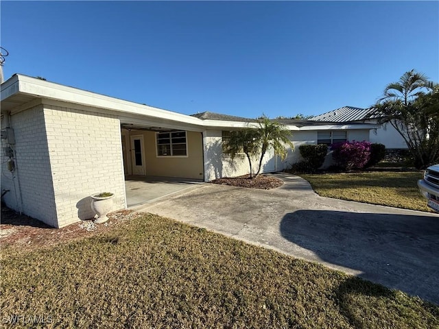 exterior space with a front lawn and a carport