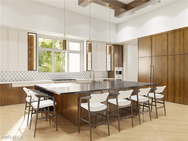 799 Cassena Rd, Naples, FL 34108 - kitchen with modern cabinets, brown cabinetry, a sink, decorative backsplash, and beamed ceiling