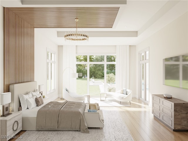 799 Cassena Rd, Naples, FL 34108 - bedroom with a chandelier, a raised ceiling, wood finished floors, and baseboards