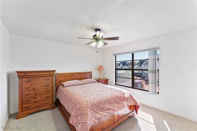 bedroom with ceiling fan and light carpet