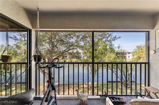 unfurnished sunroom with a water view