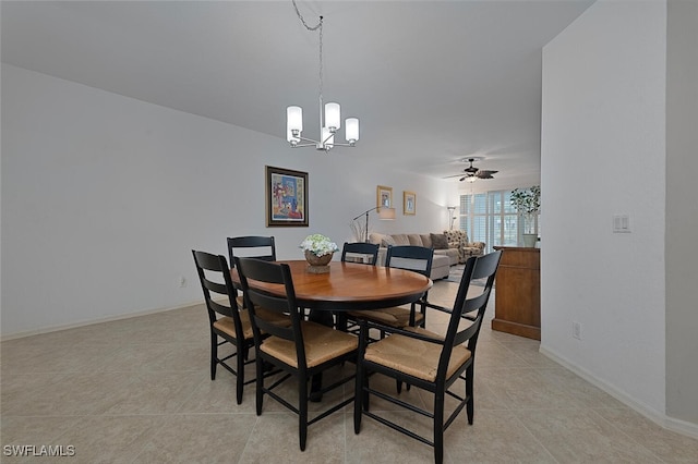 tiled dining area featuring ceiling fan with notable chandelier