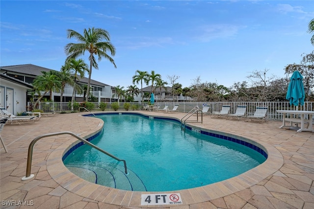 view of swimming pool with a patio area