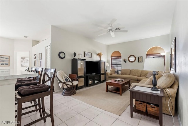 tiled living room with ceiling fan