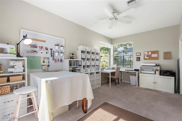 carpeted office space with ceiling fan