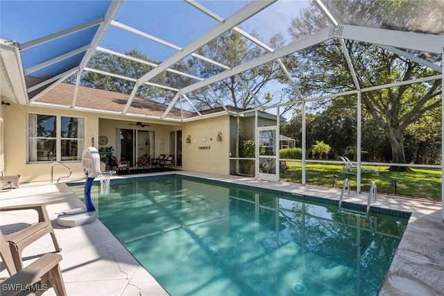 view of swimming pool featuring a lanai, a patio, and ceiling fan