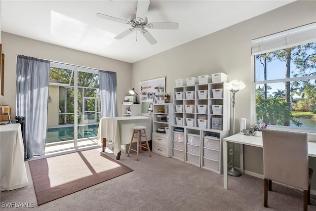 office space featuring ceiling fan, carpet flooring, and a water view