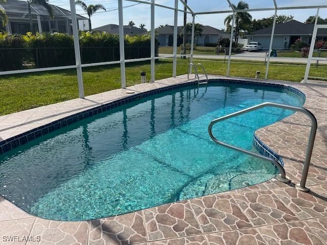 view of pool featuring a patio area and a yard