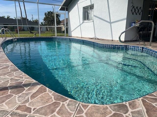 view of pool featuring a lanai and a patio