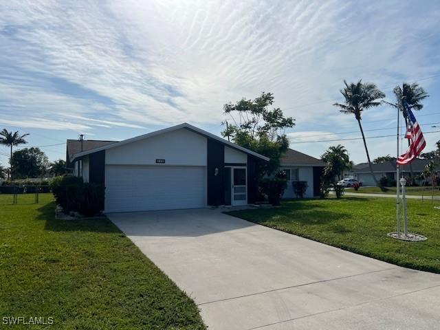 single story home featuring a garage and a front yard