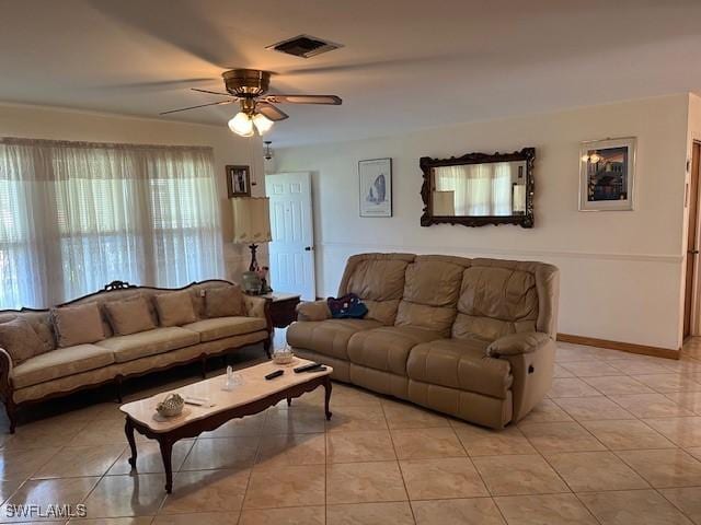 tiled living room with ceiling fan