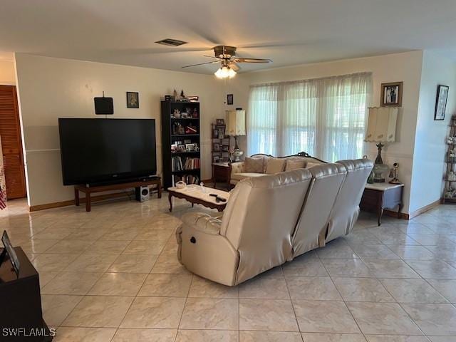 living room featuring ceiling fan and light tile patterned flooring