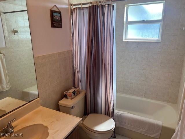 full bathroom featuring vanity, shower / bath combination with curtain, tile walls, and toilet