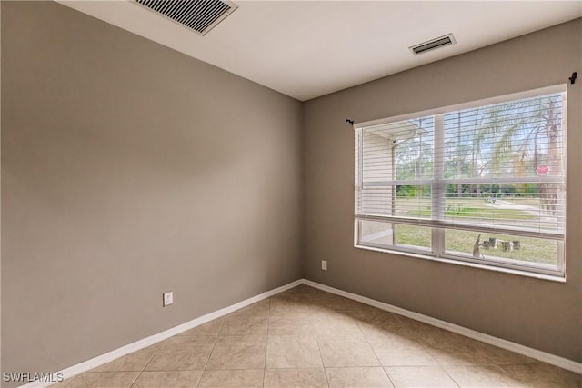 empty room with light tile patterned floors