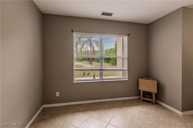 tiled empty room featuring a wealth of natural light