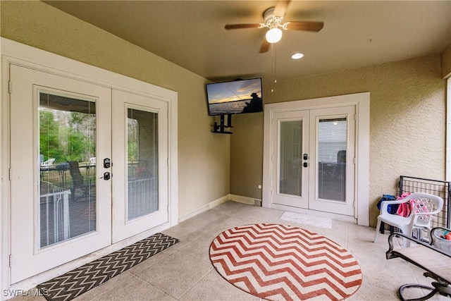 entrance to property with french doors, a patio, and ceiling fan