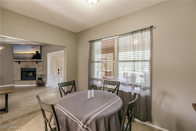 dining area featuring french doors and light tile patterned floors