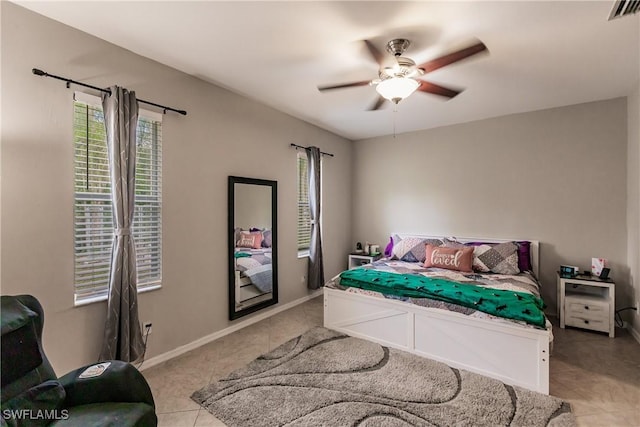 tiled bedroom with ceiling fan