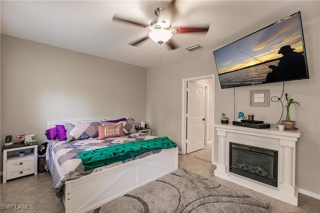 bedroom with ceiling fan and light tile patterned flooring