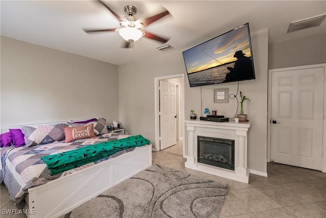 bedroom with ceiling fan and light tile patterned floors