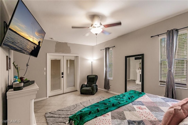 tiled bedroom with ceiling fan and french doors