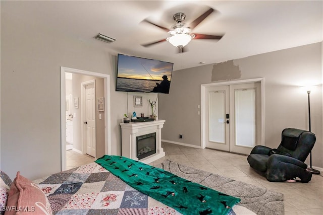 bedroom with ceiling fan and light tile patterned flooring