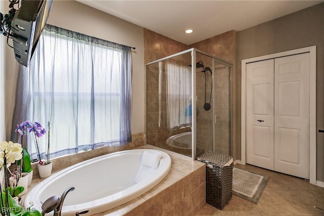 bathroom with tile patterned flooring and independent shower and bath