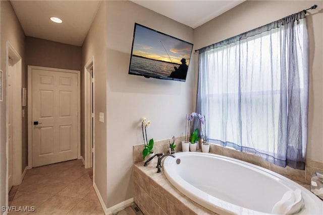 bathroom featuring tiled bath and tile patterned floors