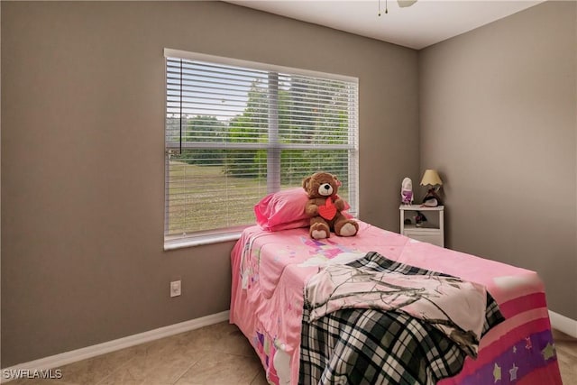 tiled bedroom featuring multiple windows